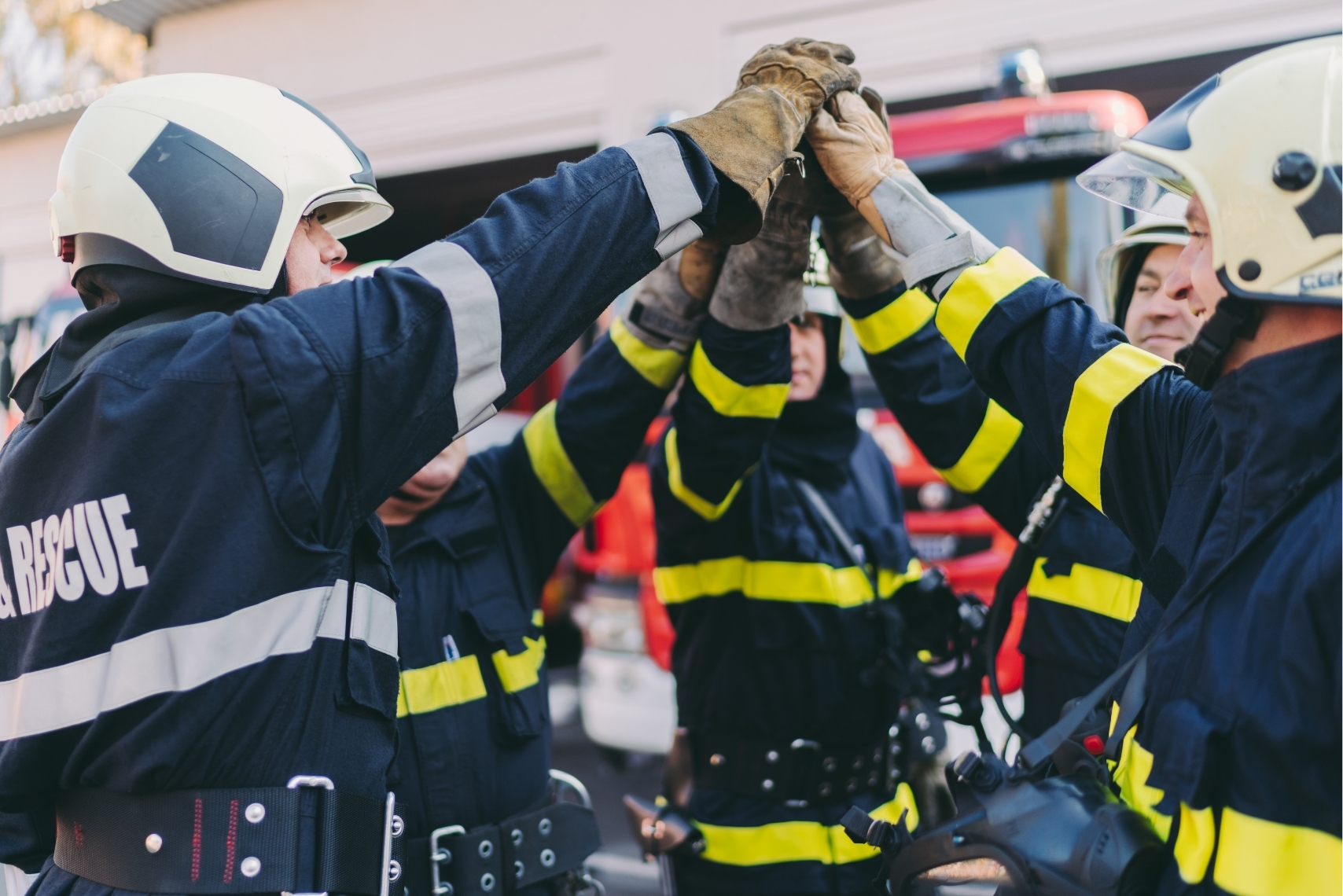 Emergency first responders in full gear coordinating at a disaster scene
